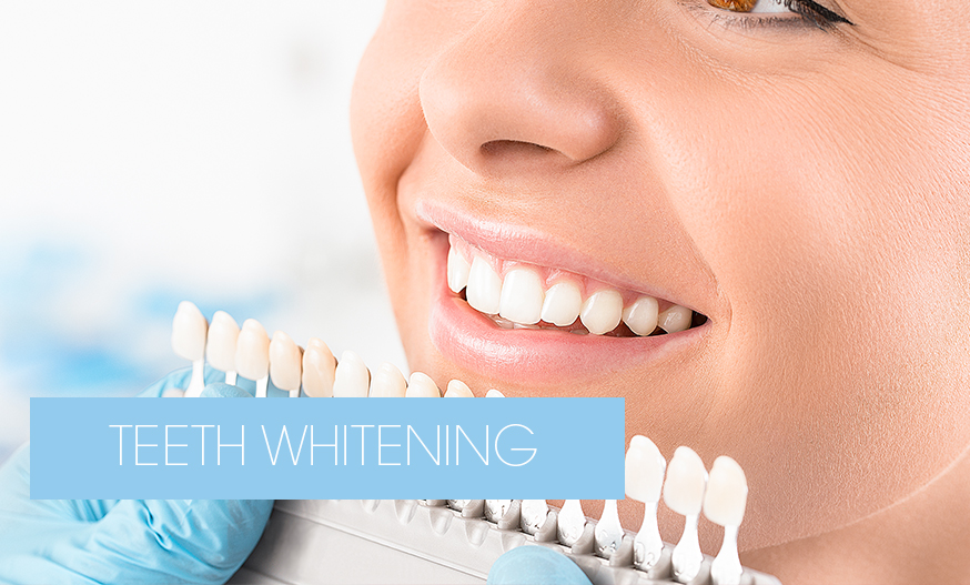 dentist checking tooth colour after teeth whitening